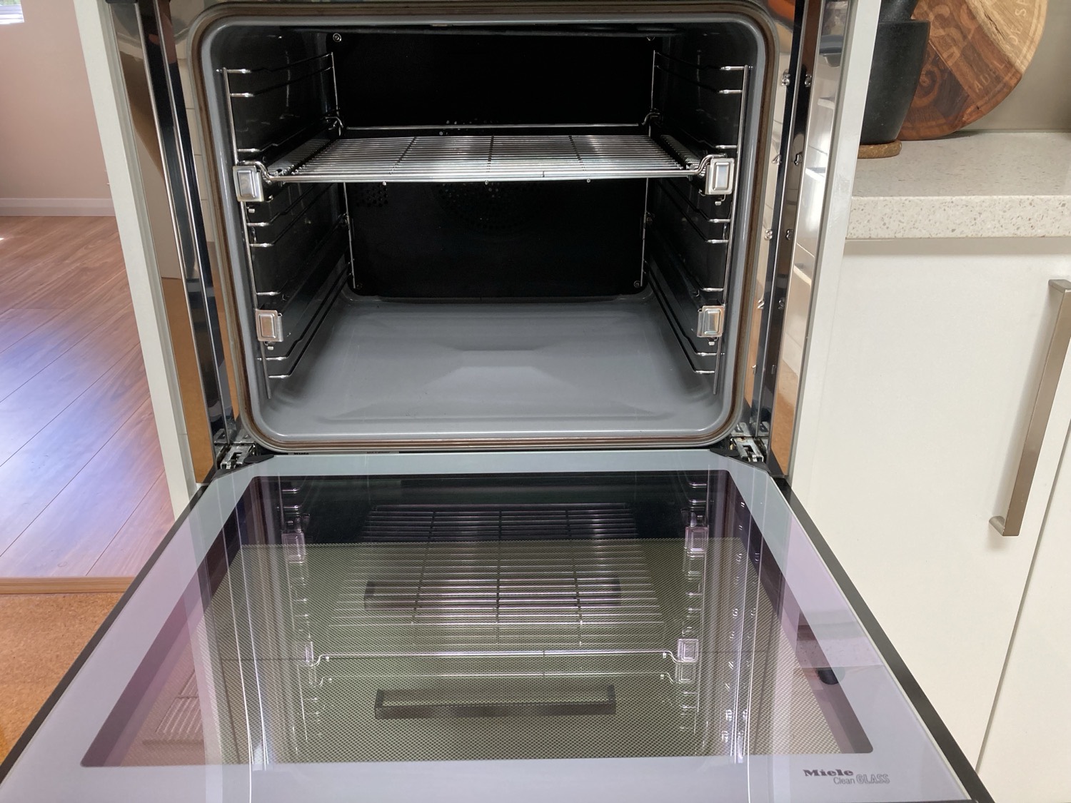 The same Miele wall oven after cleaning, interior and door glass back to clean